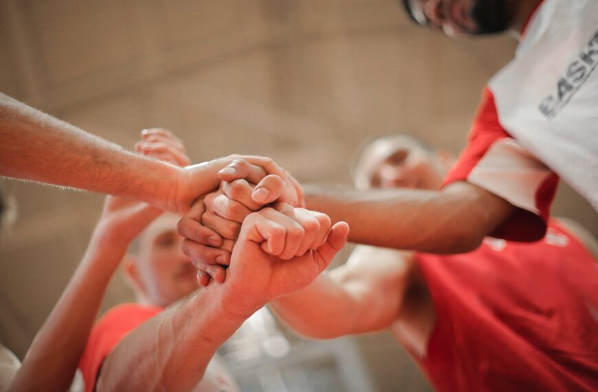 basketball team stacking hands together