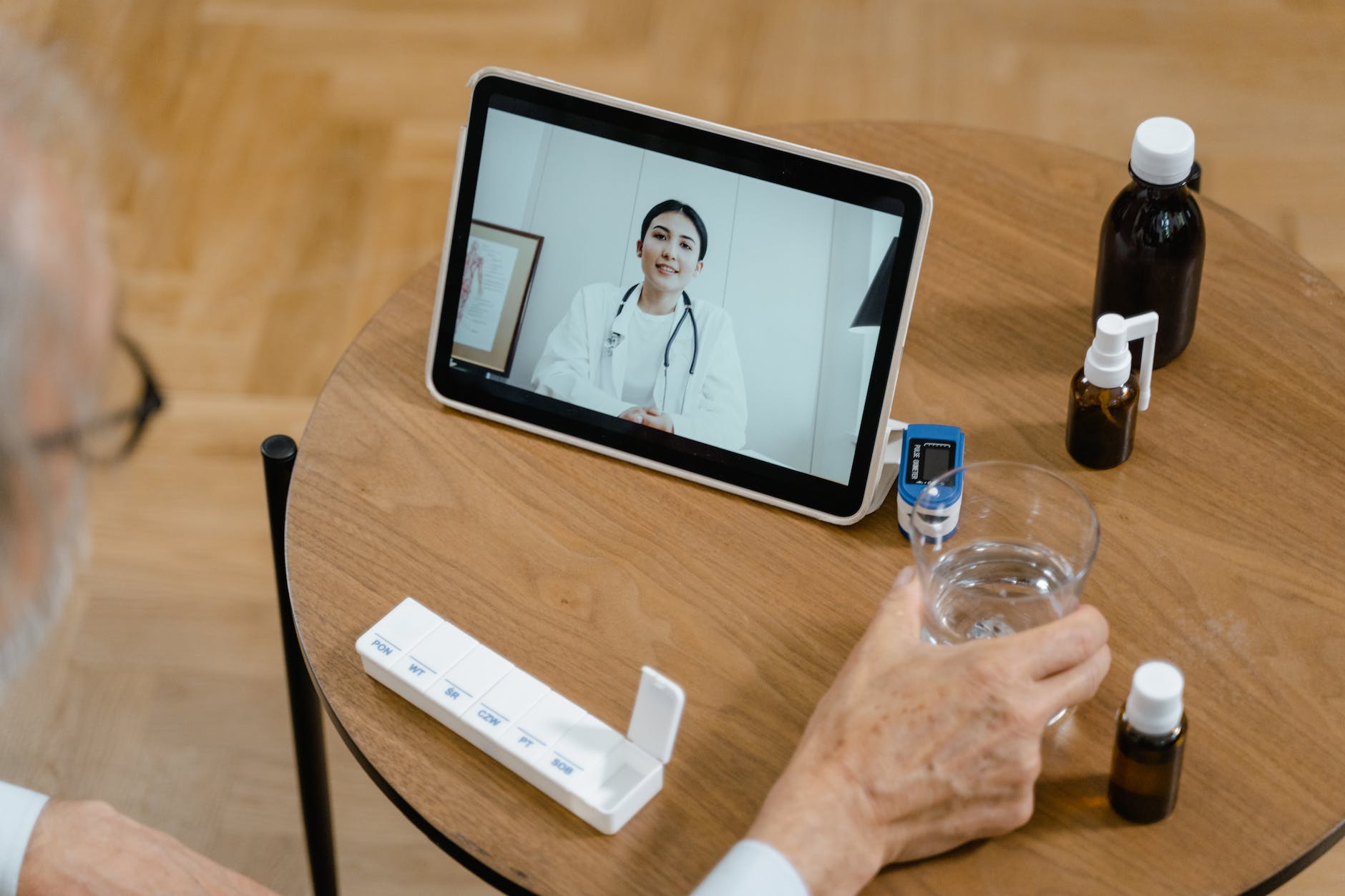 high angle shot of a person making a zoom call to a doctor