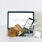 a miniature shopping cart on macbook laptop