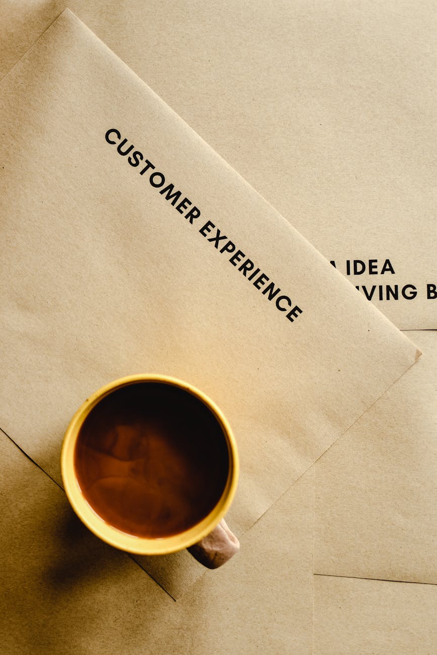 a top shot of a cup of coffee on brown envelopes