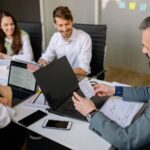 employees happily having a meeting with their boss