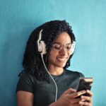 woman in black crew neck t shirt wearing white headphones