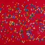 colorful dots against red background