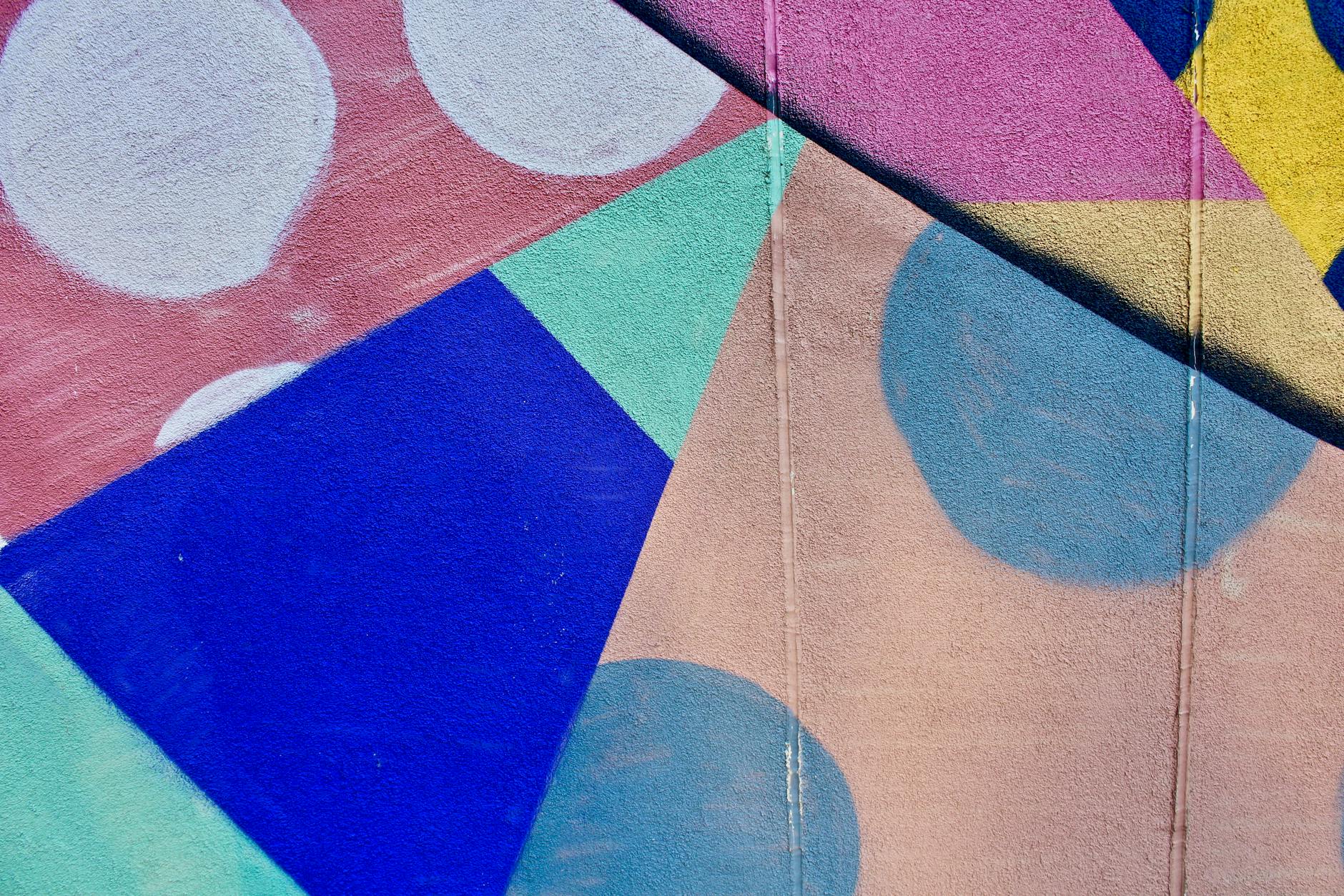colorful shapes and patterns painted on flat surface