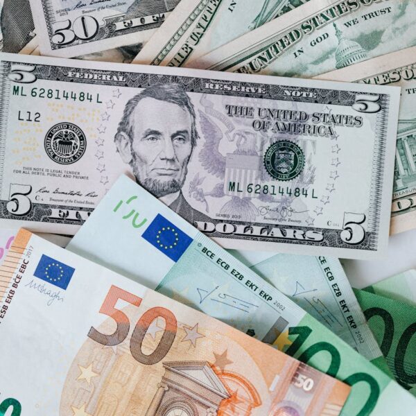stack of different currency with photo of men and buildings