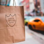 shopping bag with inscription hanging on street