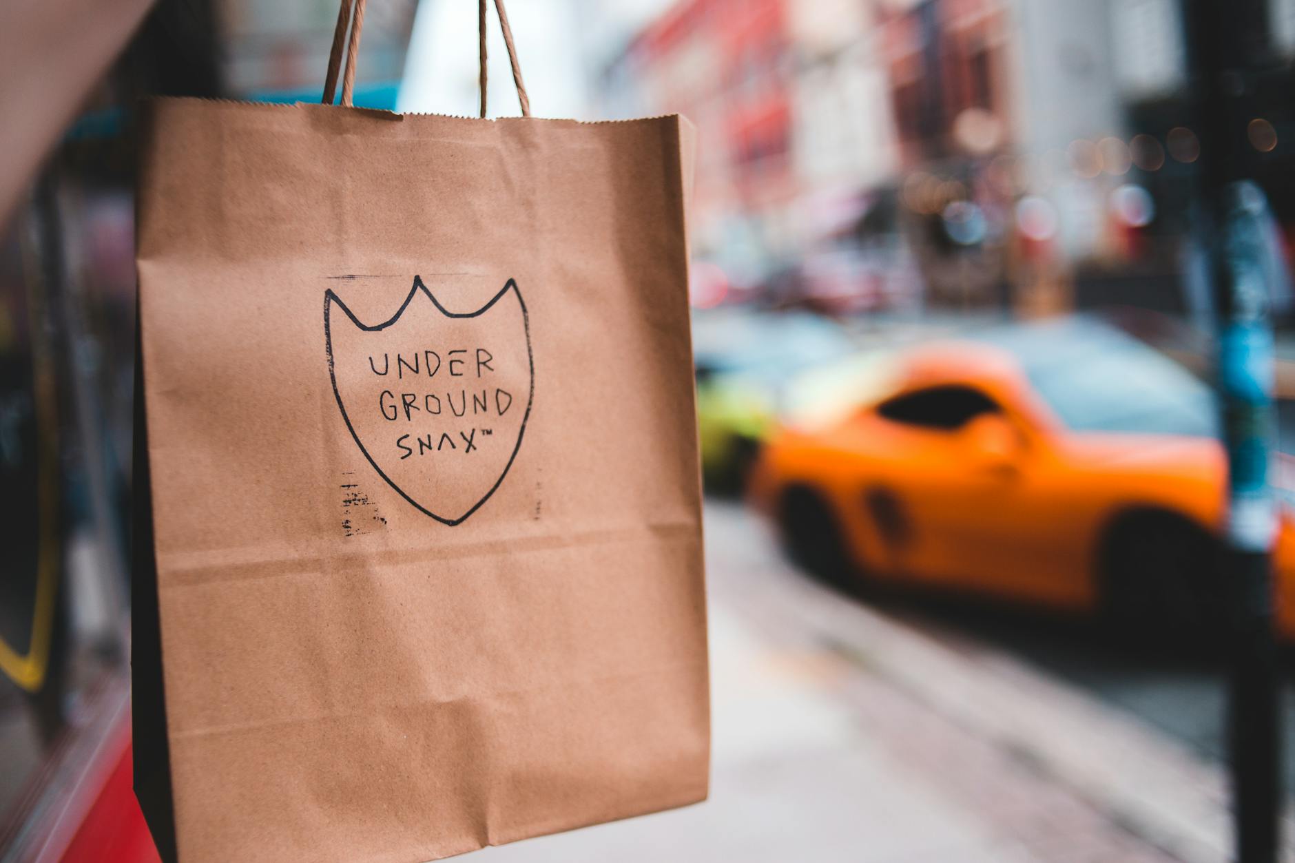 shopping bag with inscription hanging on street