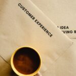 a top shot of a cup of coffee on brown envelopes