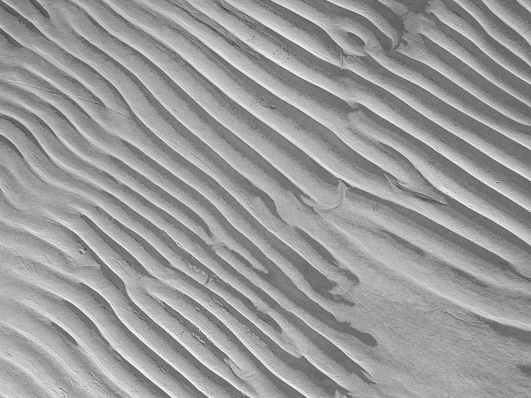 shapes on sand in black and white