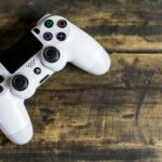 white gaming console on wooden surface