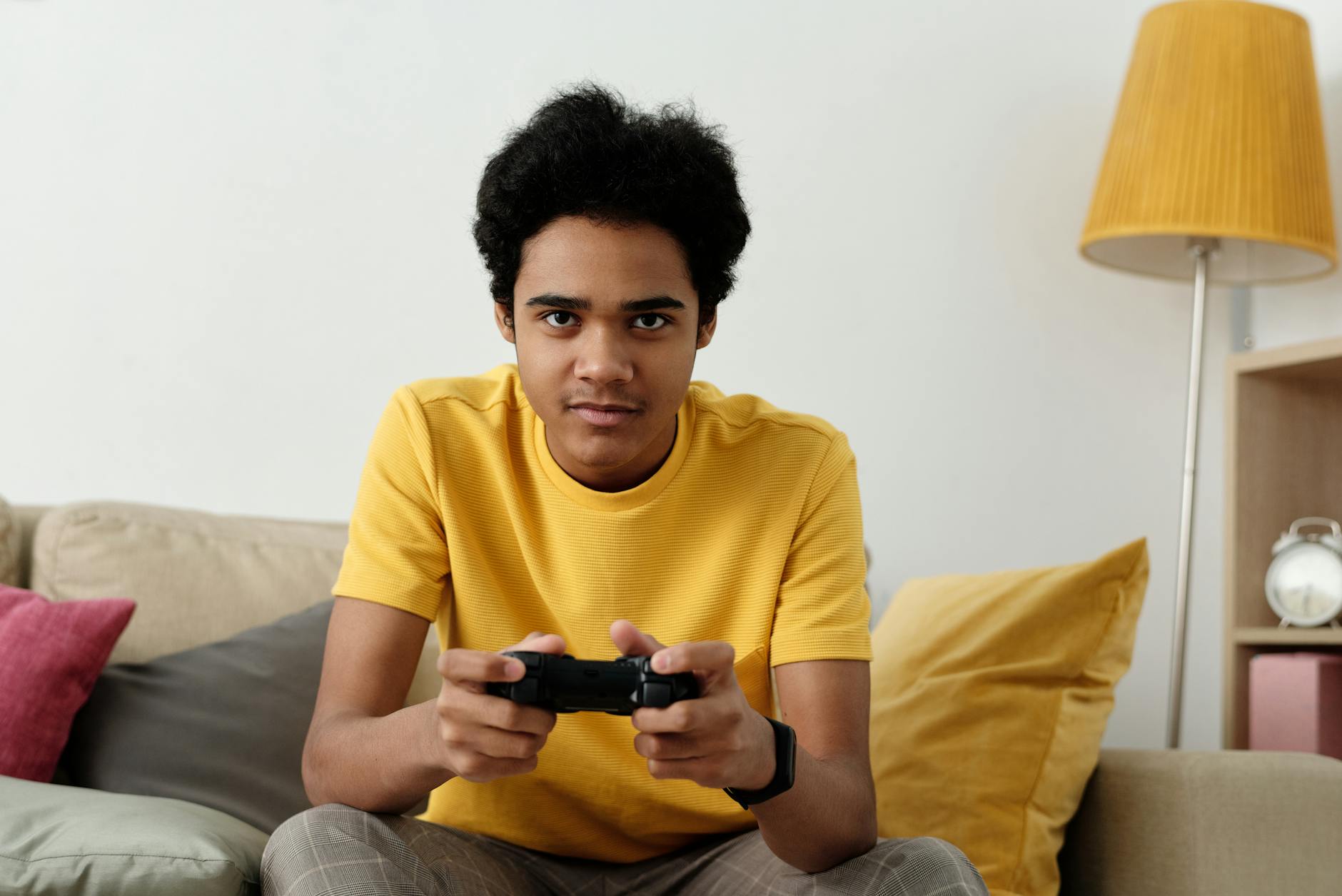 man in yellow crew neck t shirt sitting on bed