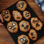 brown cookies decorated with various facial expressions