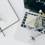 a miniature shopping cart on macbook laptop