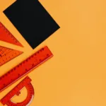 assorted rulers beside a black paper