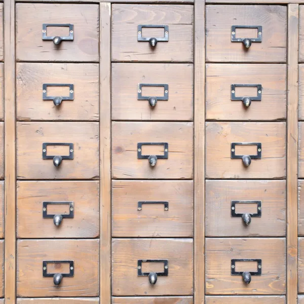 many identical wooden boxes with round handles