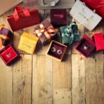 assorted gift boxes on brown wooden floor surface