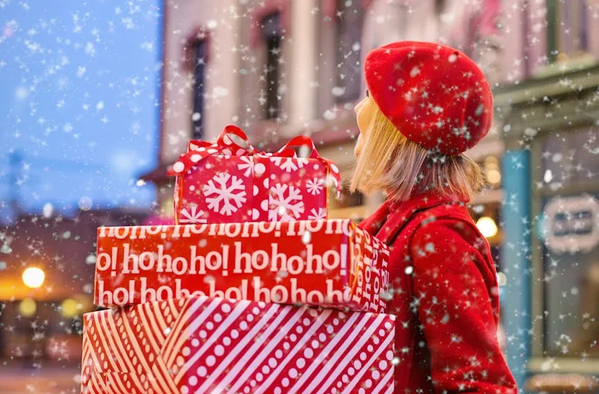 woman holding three red christmas presents boxes