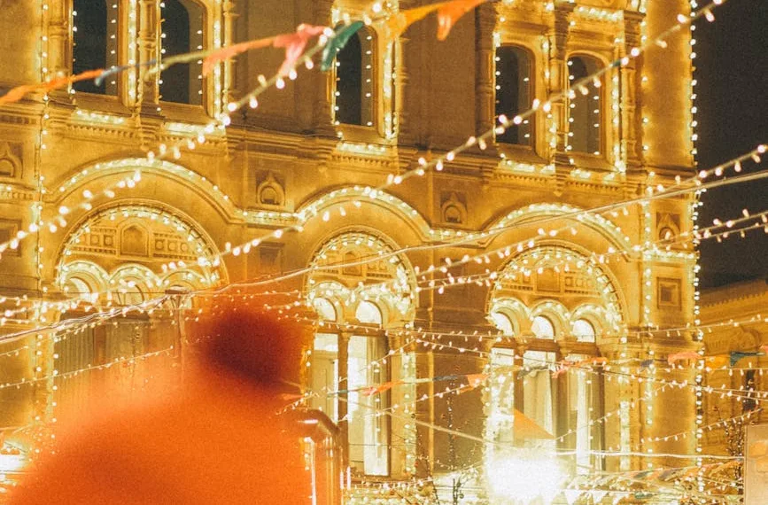 festive night market with illuminated historic building