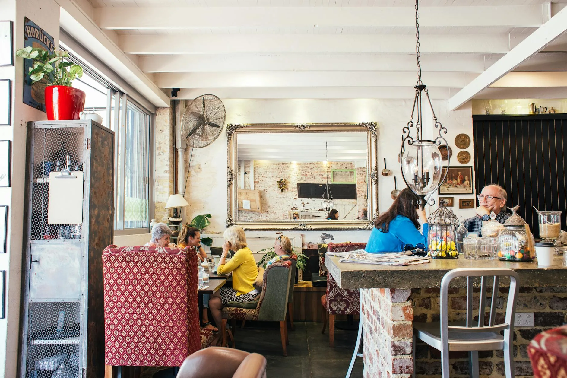 anonymous customers having break in cozy cafe