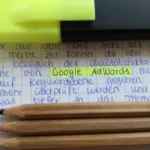yellow highlighter marker and color pencils on a notebook