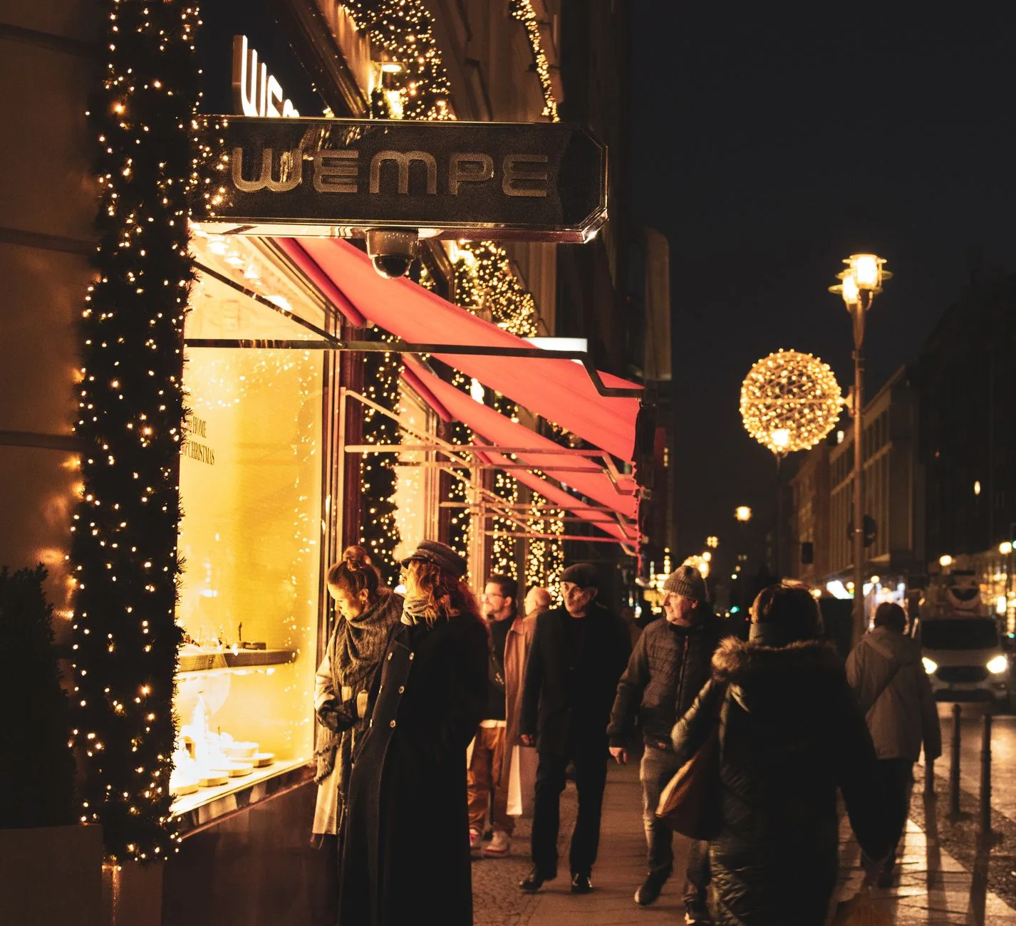 people walking on the street at night